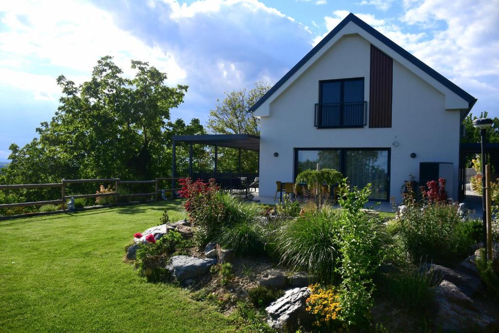 a white house with a garden in front of it at Vila Vinita in Sveti Jurij ob Ščavnici