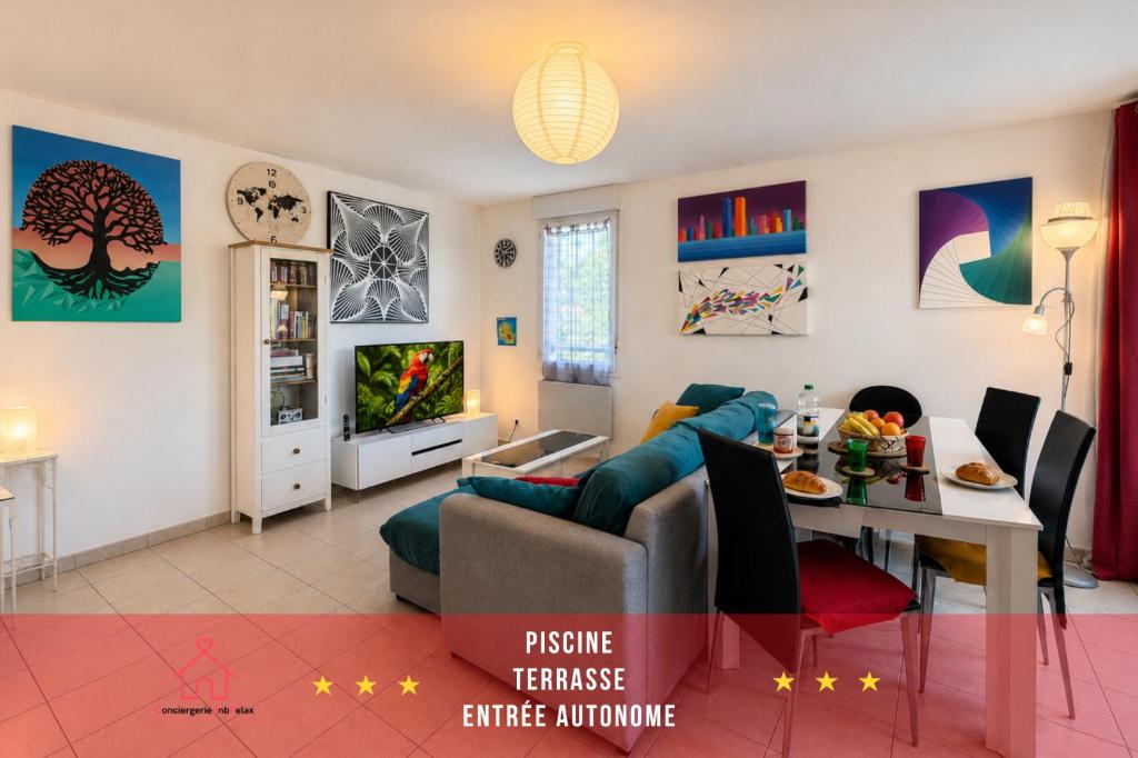 a living room with a couch and a table at " Régussol Coloré " Piscine - Linge fourni - Wifi in Castelnau-dʼEstrétefonds