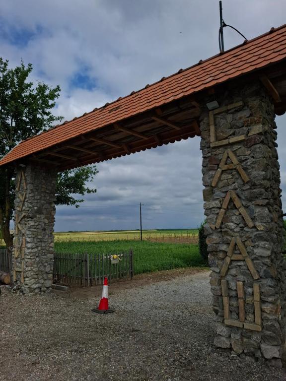 a stone pavilion with a red cone under it at Lukin salaš broj 3 in Ratkovo