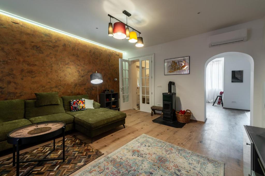 a living room with a couch and a table at Apartment Grof Janko - Luxury in the Center - TERRACE & FREE PARKING in Karlovac