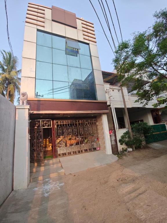 a building with a gate in front of it at SEYONE stay in Kanchipuram