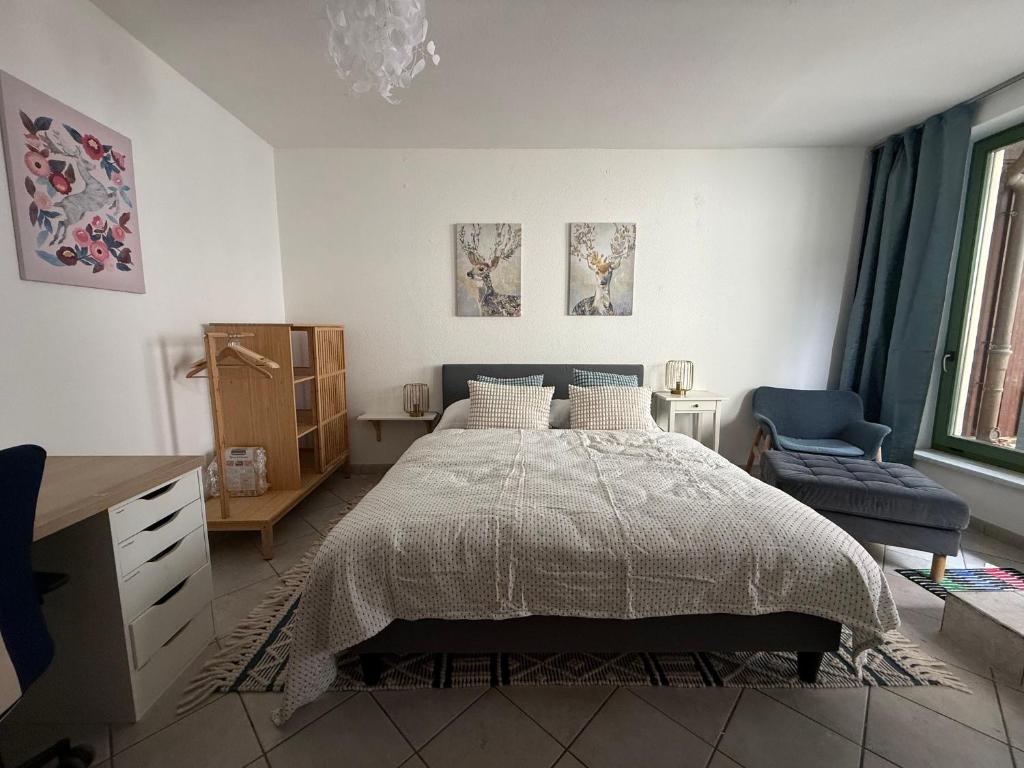 a bedroom with a bed and a desk and a chair at Hygge Cabin in Rostock
