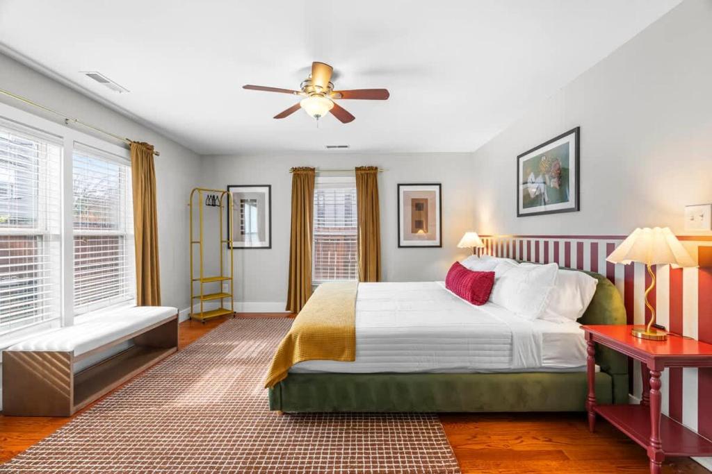 a bedroom with a bed and a ceiling fan at Backyard Hangout Firepit Giant Connect 4 & BBQ in Raleigh
