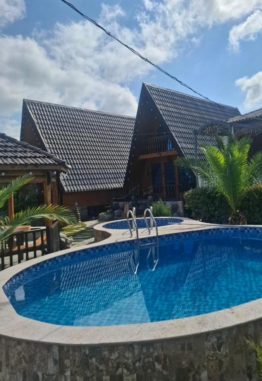 a swimming pool in front of a house at Toma's Nest-თომას ბუდე in Martvili
