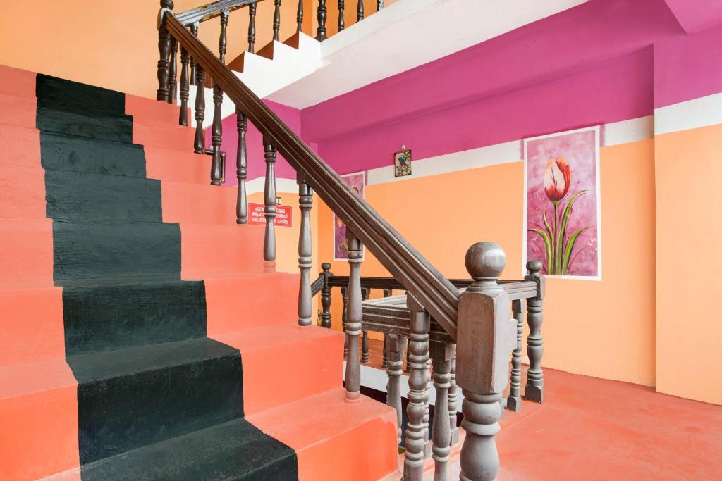 a staircase in a house with colorful walls at Hotel O SSR residency in Venjāramūdu