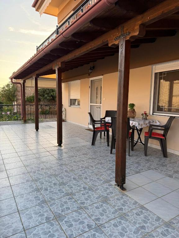 an outdoor patio with a table and chairs at Dimi's Apartment Avdira in Ávdhira