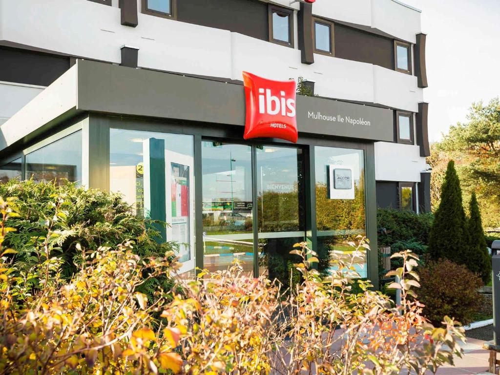 a building with a ups sign in front of it at ibis Mulhouse Ile Napoleon in Sausheim