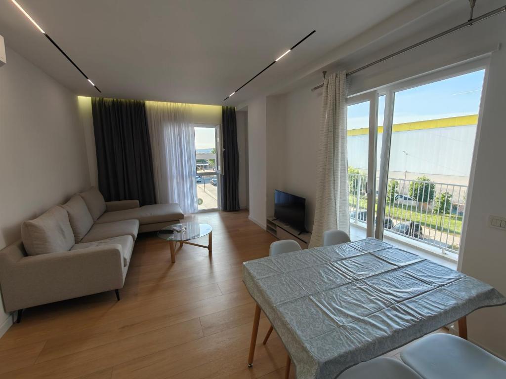 a living room with a couch and a table at DfA in Tirana