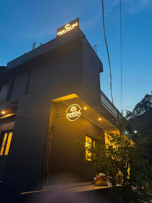 a building with a clock on the side of it at Hotel Casa Del Sol Near'Bhimtal Lake in Bhīm Tāl