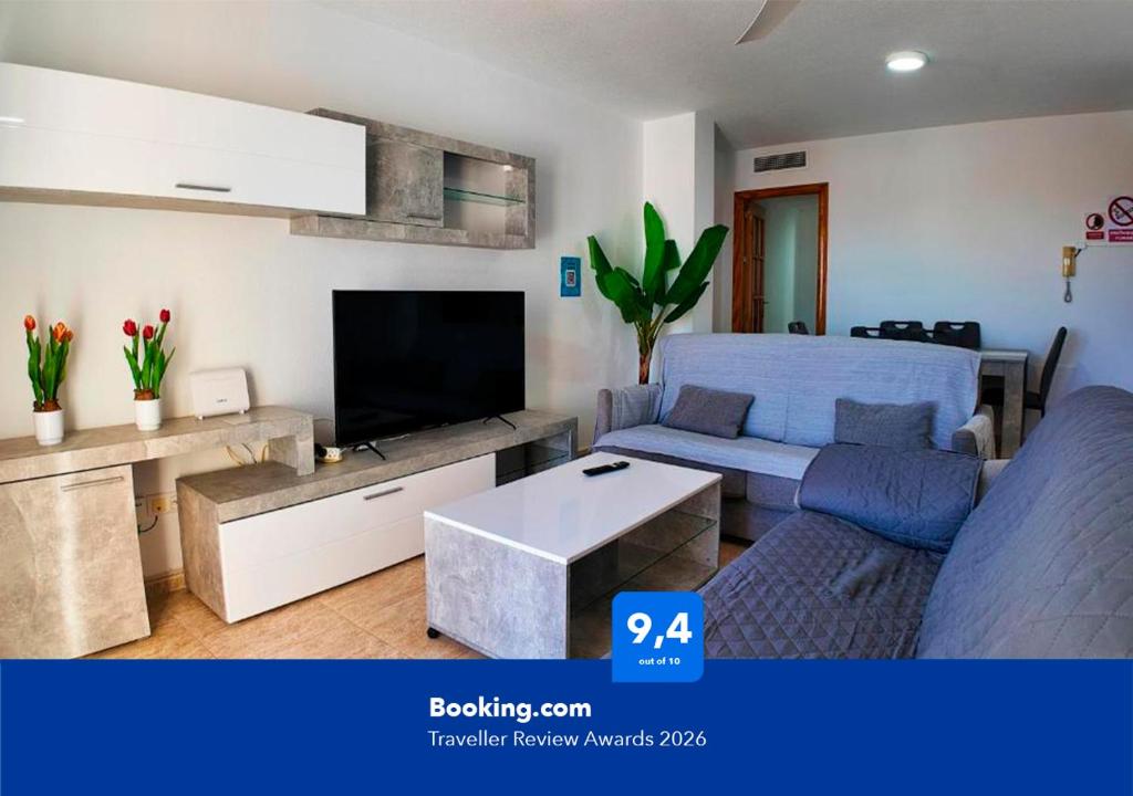 a living room with a couch and a tv at Apartalux Star Magic II in Águilas