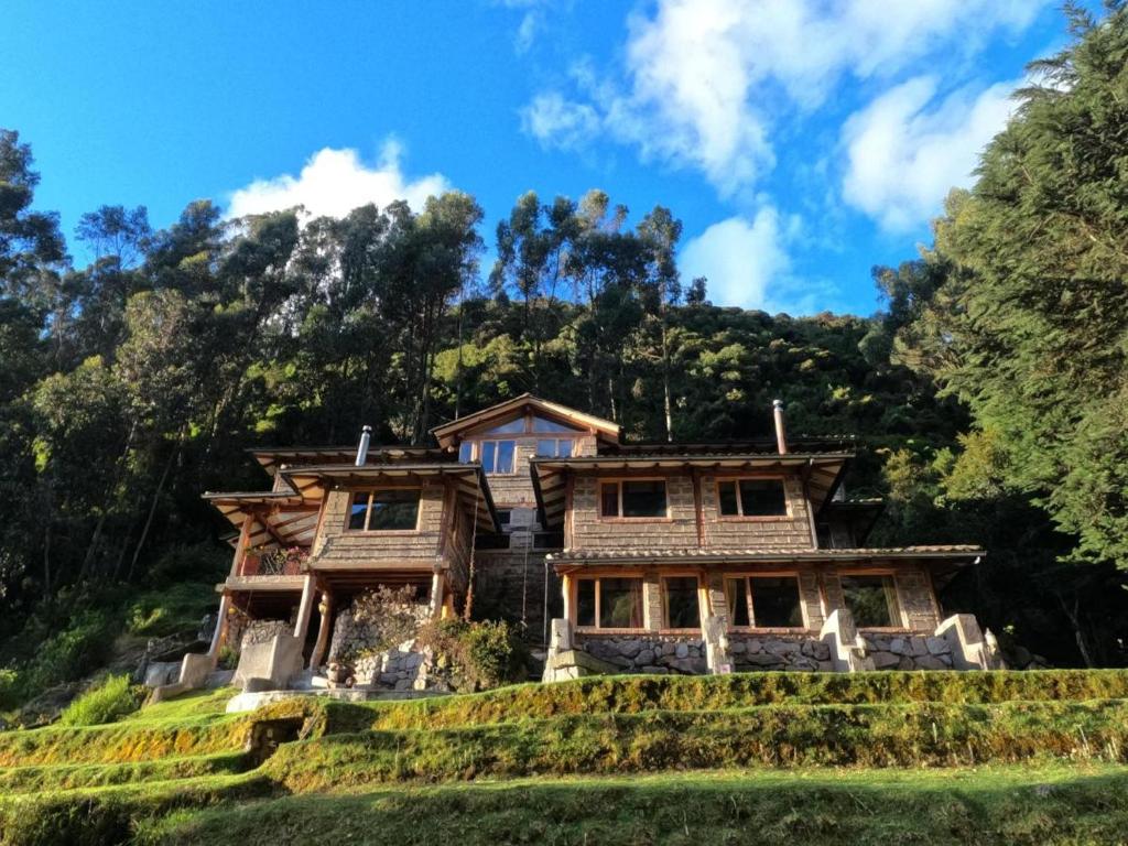 a house on a hill with trees at Hacienda Rumiloma in Quito