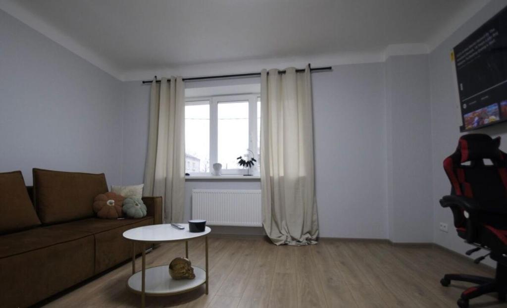 a living room with a couch and a table at ST Luxury Apartment Riga in Riga