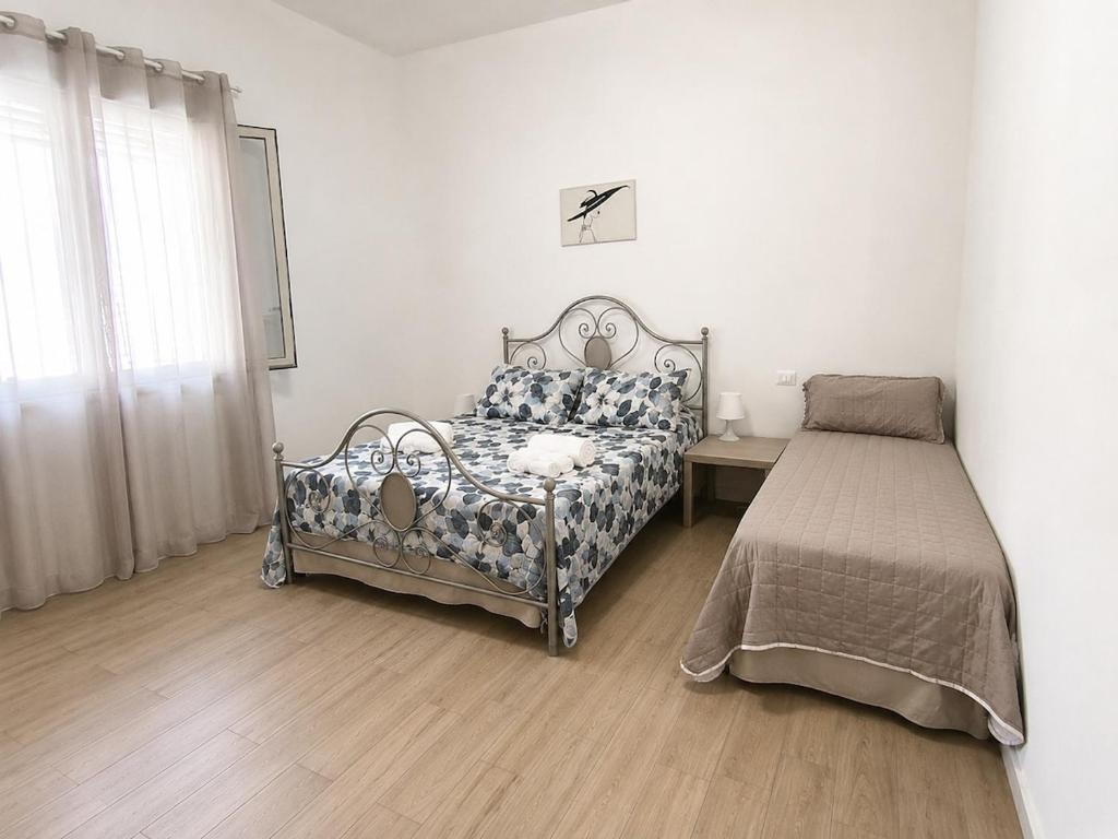 a bedroom with a bed next to a window at Casa Luna in Paceco