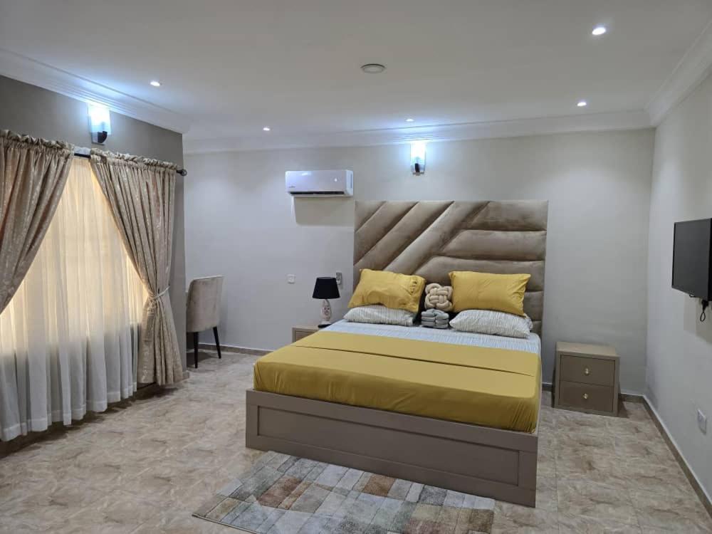 a bedroom with a large bed and a television at Luxury Home Away in Aja