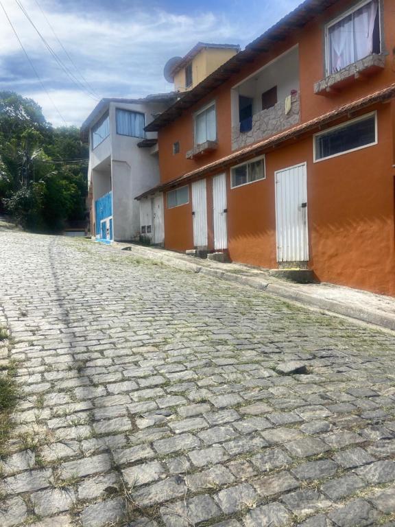 a cobblestone street in front of a building at Antonia Hospedaria 1 in Búzios
