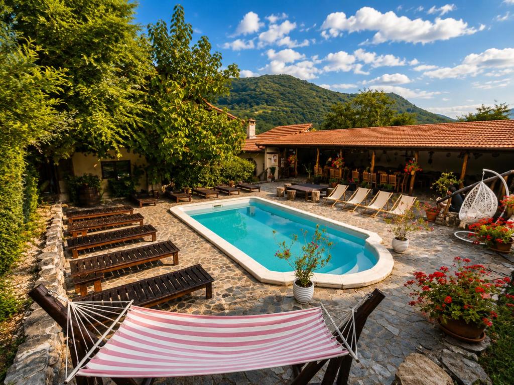 a swimming pool with lounge chairs and a house at Casa Dives - Varianta Boierească in Pianu de Sus