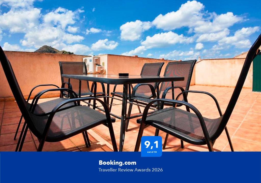 a black table and chairs on a balcony at Apartalux Calas Magic in Calasparra
