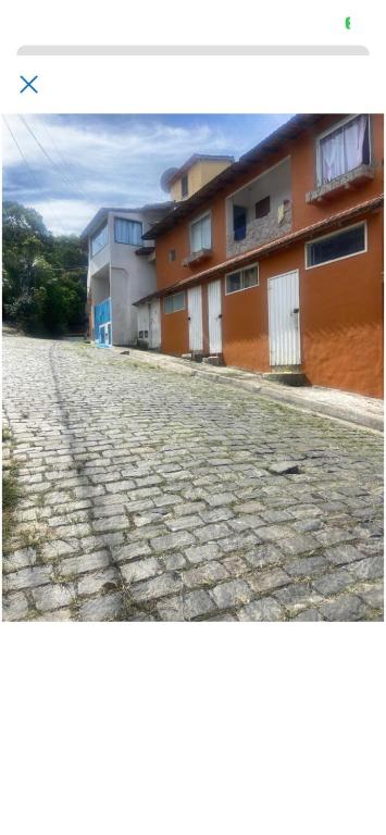 a cobblestone street in front of some buildings at Antonia Hospedaria 4 in Búzios