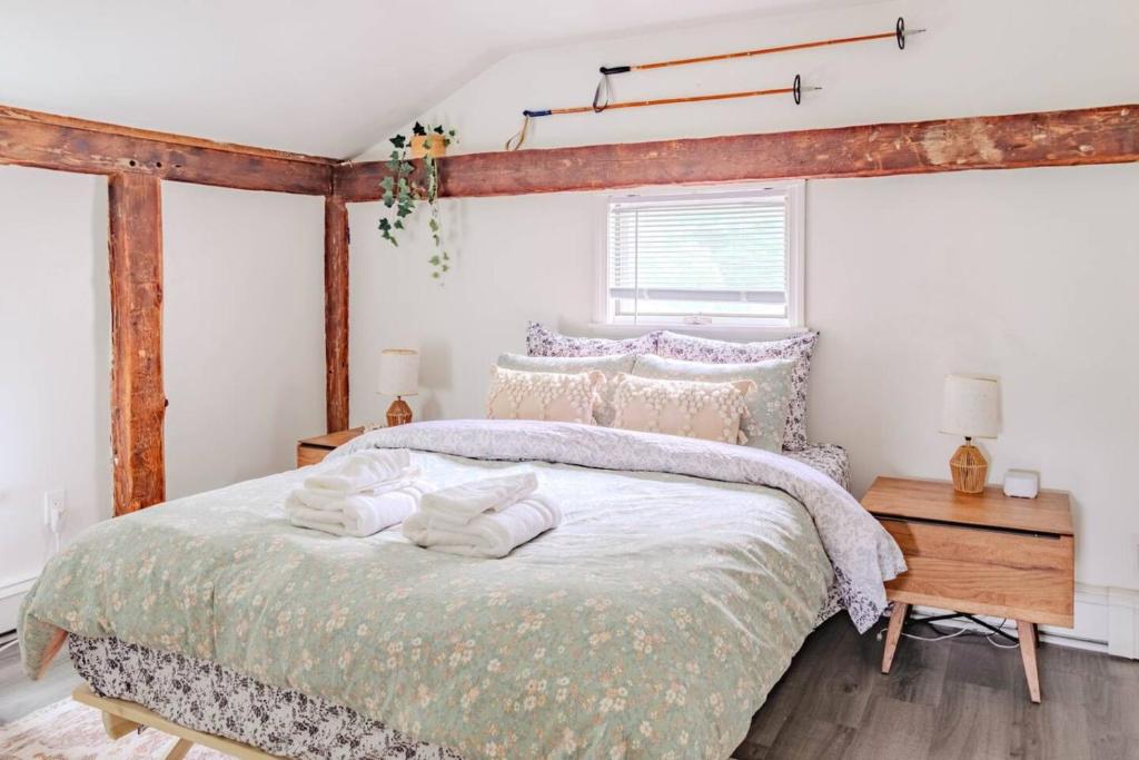 a bedroom with a bed with towels on it at Cute Stowe Apartment in Stowe