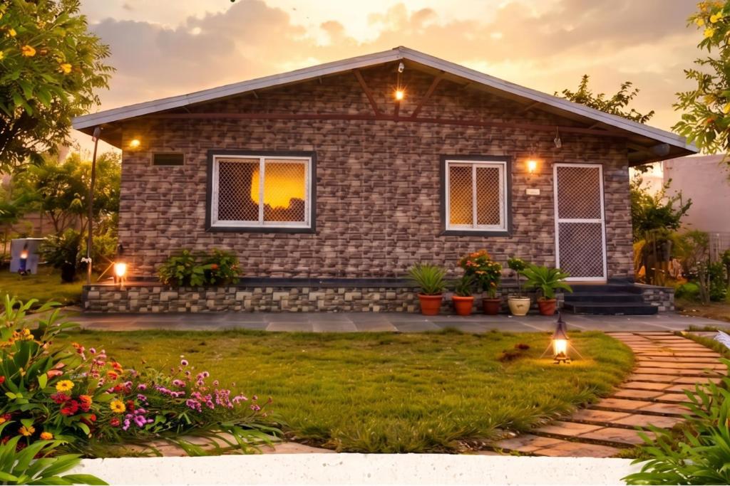 a small house with a pathway in front of it at Hotel Moturi Farmstay Vemulawada in Vemalwāda