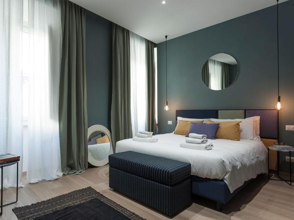 a hotel room with a bed and a lamp at Tornabuoni Place in Florence