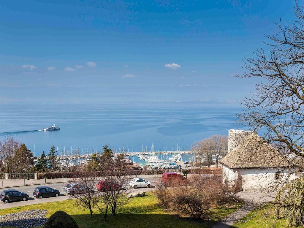 a view of a harbor with a boat in the water at ibis Thonon Centre in Thonon-les-Bains