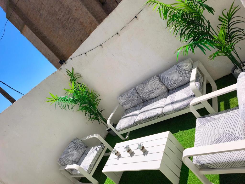 a balcony with two chairs and a bench at Casa Nentis in Mucientes