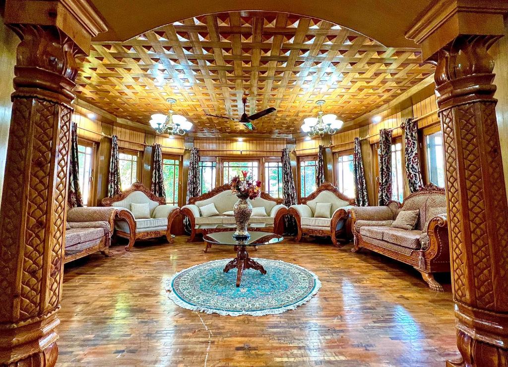 a large living room with couches and a table at Zakiyas Homestay in Srinagar