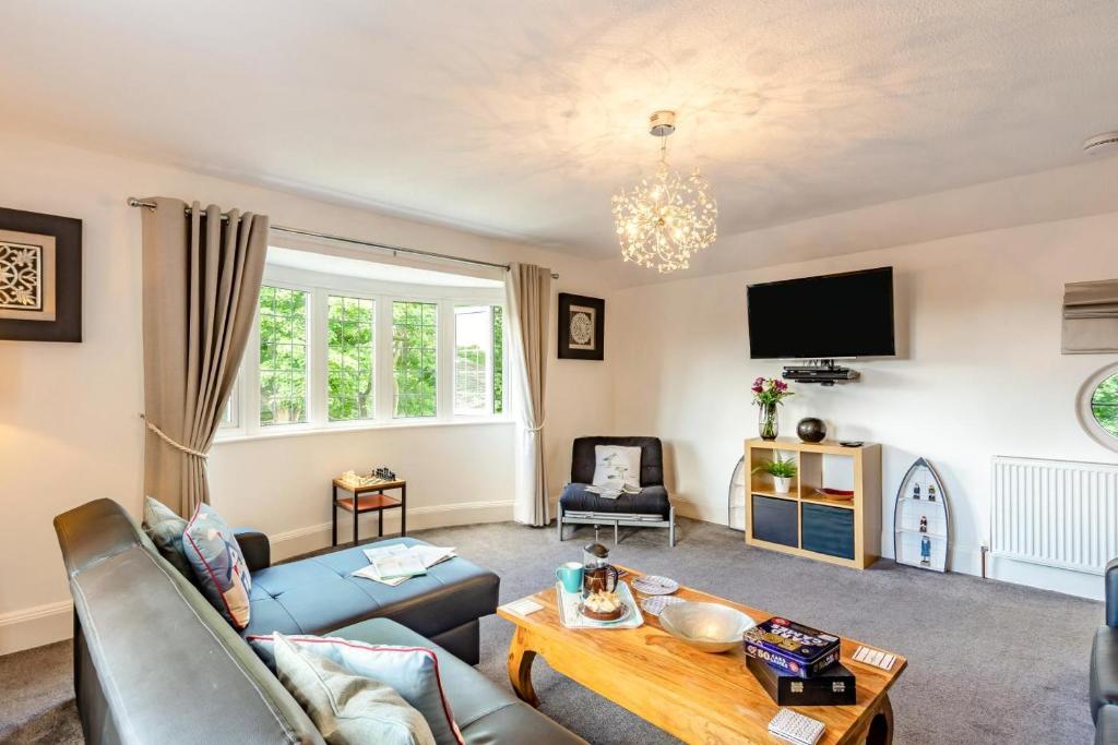 a living room with a couch and a table at 1 Bed in Filey oc-77710 in Hunmanby