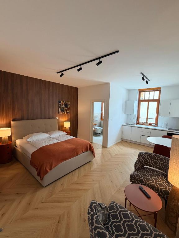 a bedroom with a bed and a living room at Street Apartment Rombon in Bovec