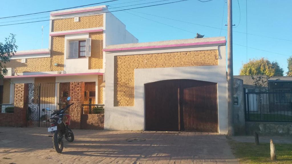 a motorcycle parked in front of a building with a garage at Posada del Baradero in Baradero
