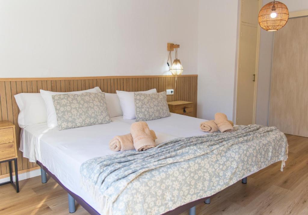 a bedroom with a bed with towels on it at Hostal San Miguel by Croma in Estepona