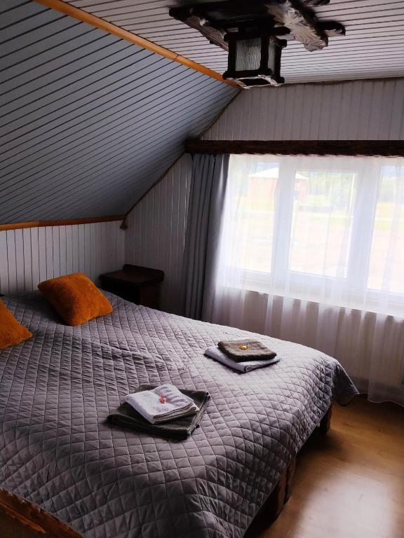 a bedroom with a bed with towels on it at Motel KOKOS in Kosiv