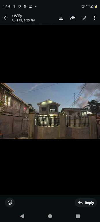 a screenshot of a picture of a house with a fence at The Rose Garden in Georgetown