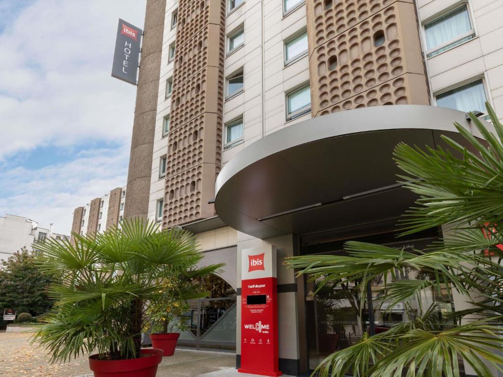 a building with a red gas pump in front of it at Ibis Paris Tour Eiffel Cambronne 15ème in Paris