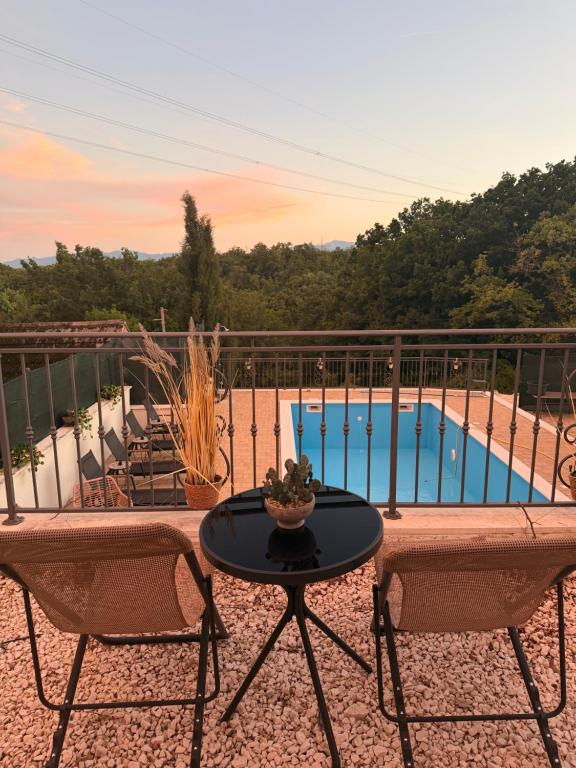 a patio with a table and chairs and a pool at Holiday Home Calma in Imotski