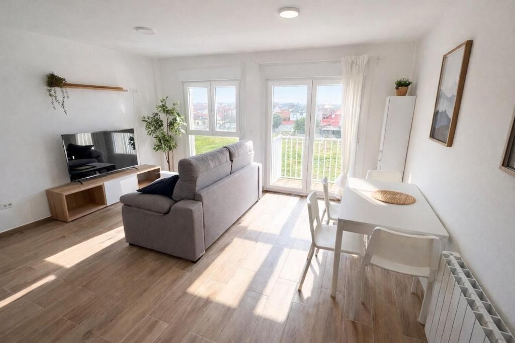 a living room with a couch and a table at AuraGalega Sagres in Ribeira