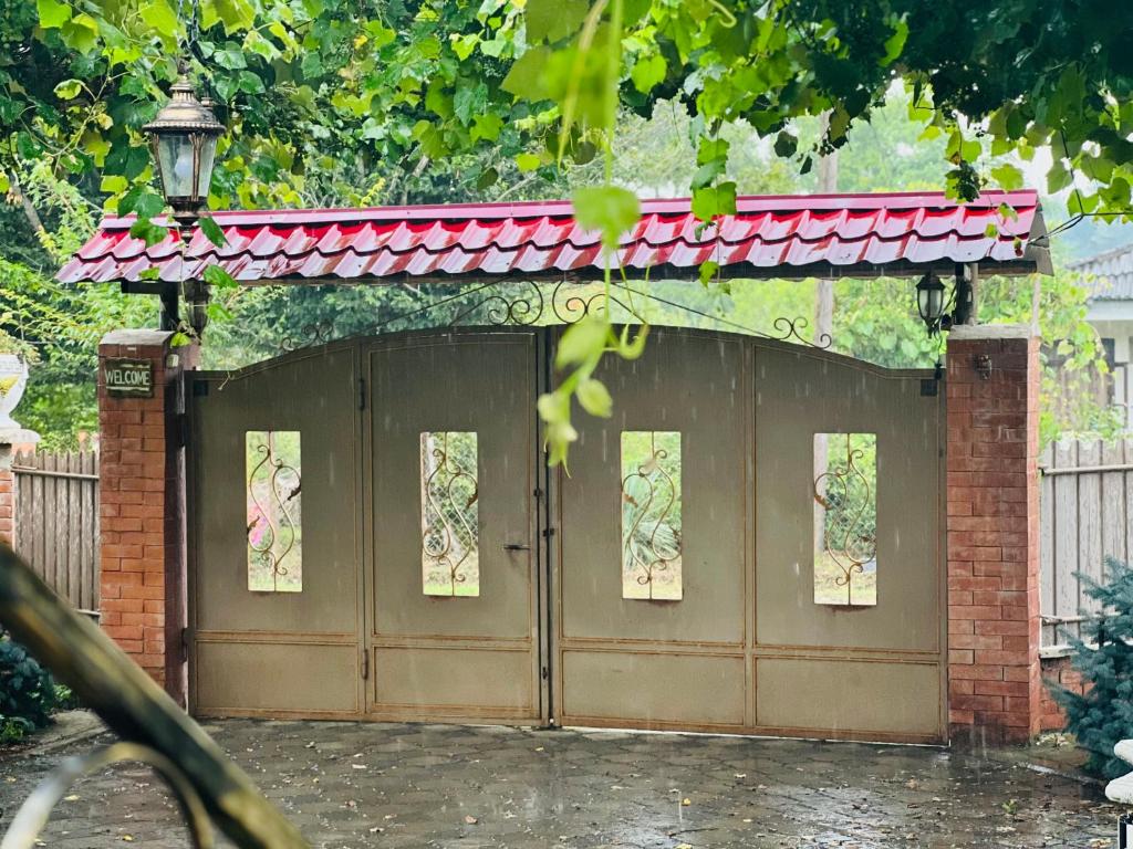 a brown garage with a red roof at SeGi Garden Home in Khobi
