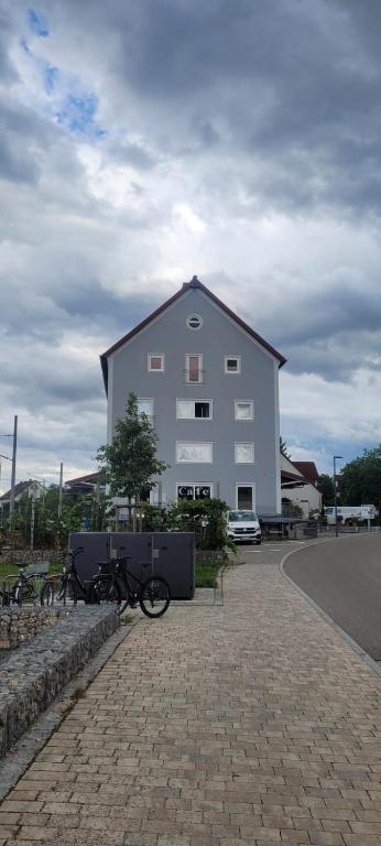 a large white building with bikes parked in front of it at Hotel Zachskorn UG in Erdweg