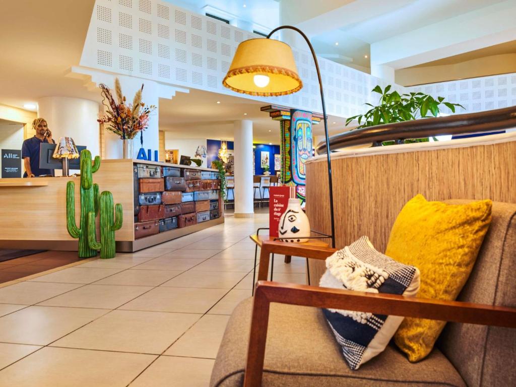 a store lobby with a couch and a lamp at ibis Paris La Villette Cité des Sciences 19ème in Paris