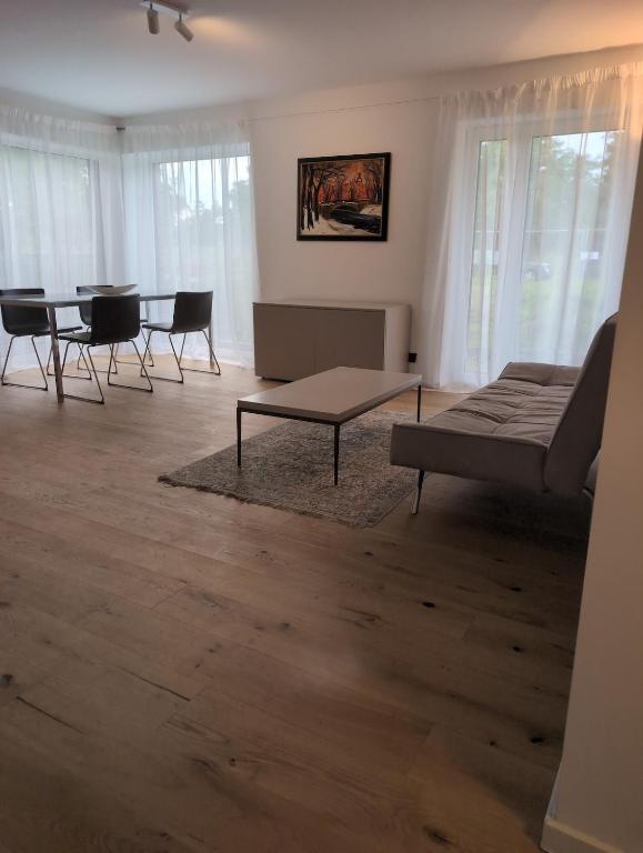 a living room with a couch and a table and chairs at Komfortables 2-Zimmer Apartment in Rinteln in Rinteln