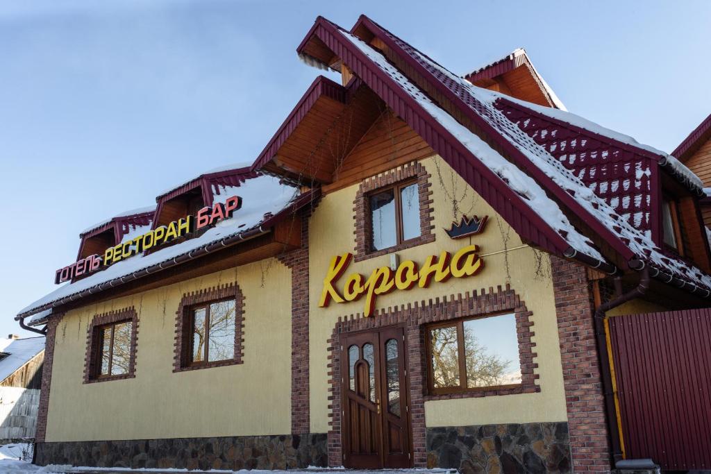 ein Haus mit einem Schild auf der Vorderseite in der Unterkunft Korona Karpat in Laseschtschyna