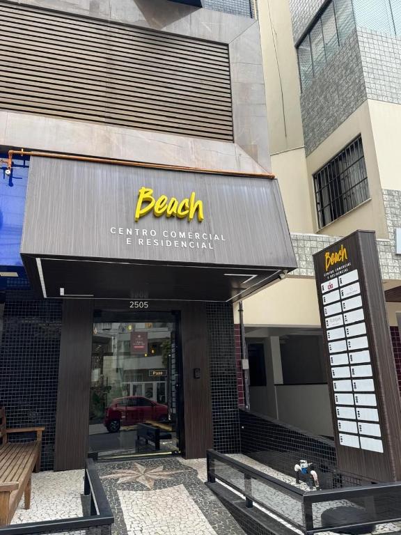 a beak restaurant with a sign on a building at Pousada Beach in Capão da Canoa