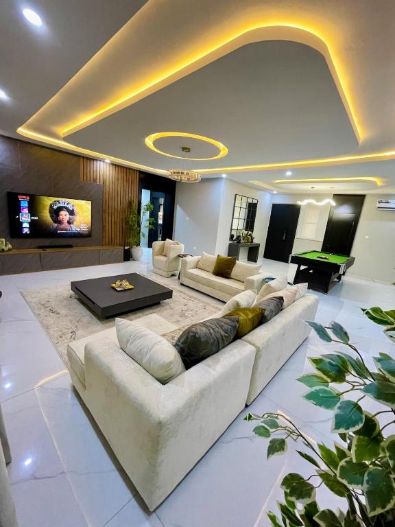 a living room with a couch and a table at Luxurious Altitude in Lekki