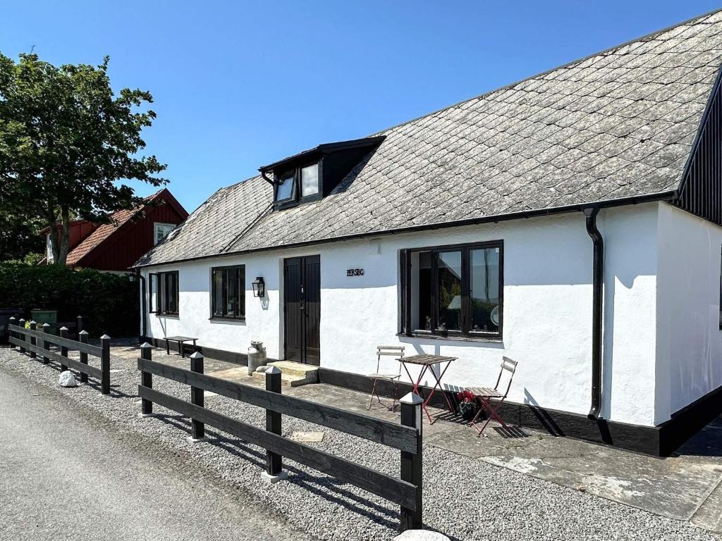 a white house with a fence in front of it at 8 person holiday home in Beddingestrand-By Traum in Beddinge Strand