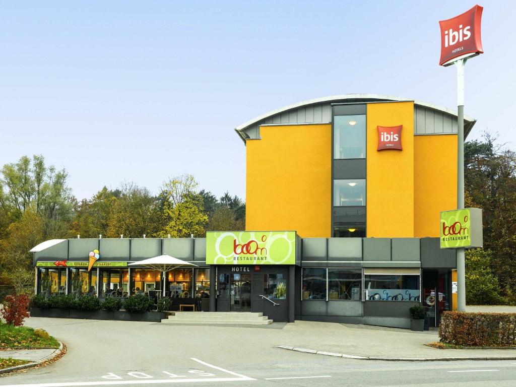 a mcdonalds building with a fast food restaurant at ibis Zurich Adliswil in Zurich
