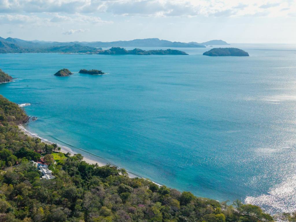an aerial view of a beach with islands in the water at Reunion Wellness Resort & Retreats in Playa Danta