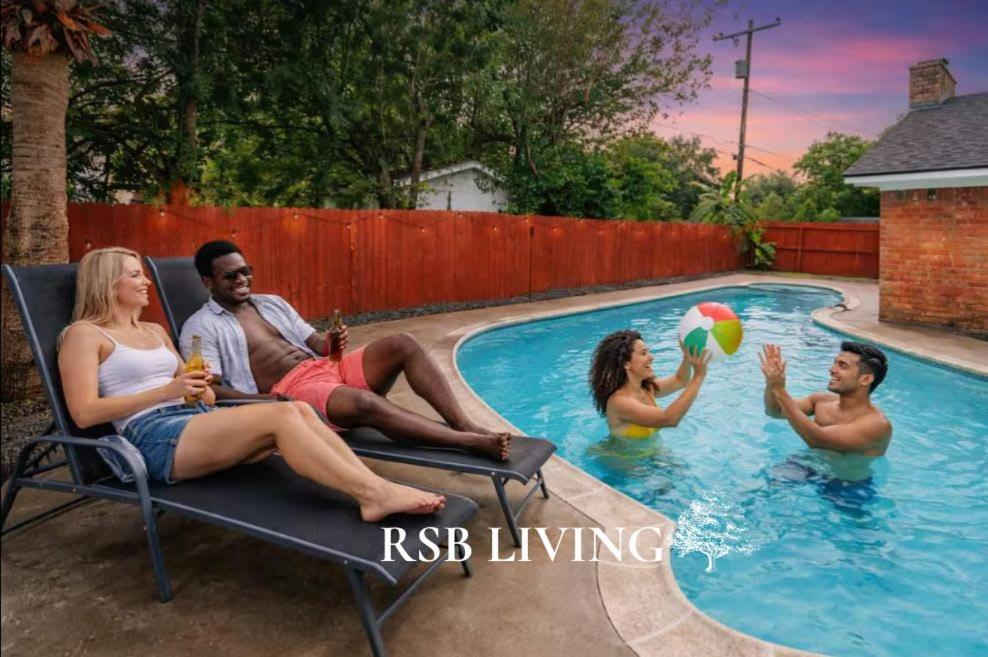 a group of people sitting in a swimming pool at Amazing 4BR 2BA Winter Home with Pool & Game-Movie Room in Texas City