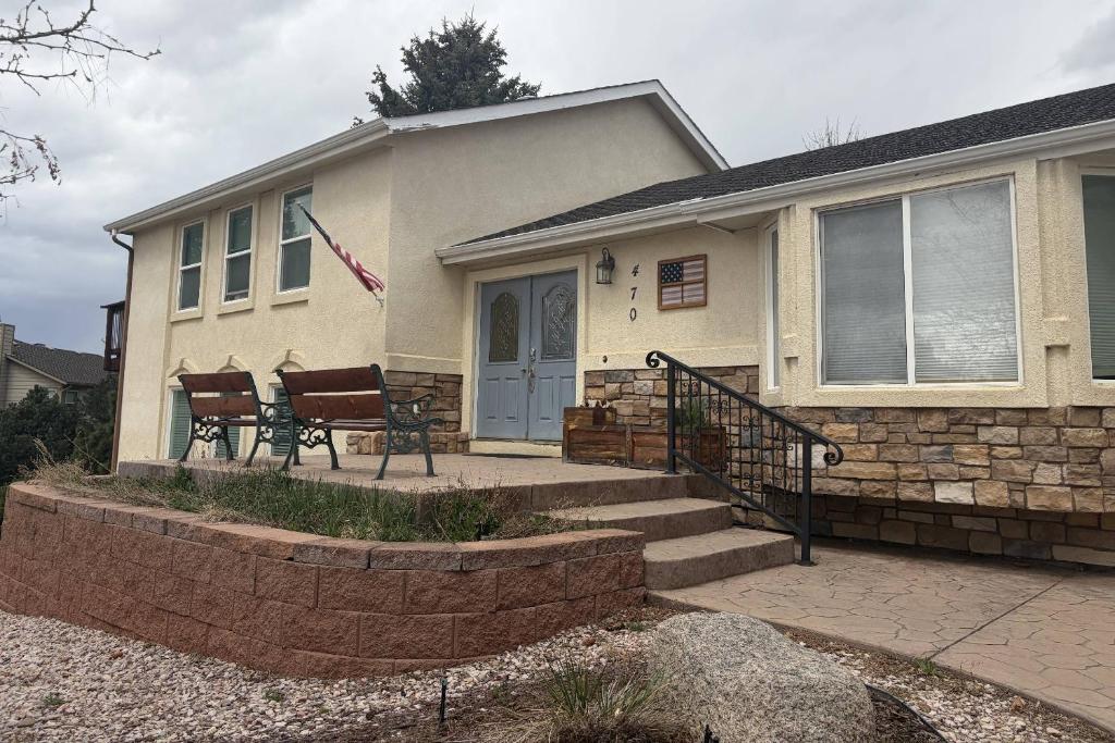 a house with a bench in front of it at Glen Eagles Cozy Queen in Colorado Springs