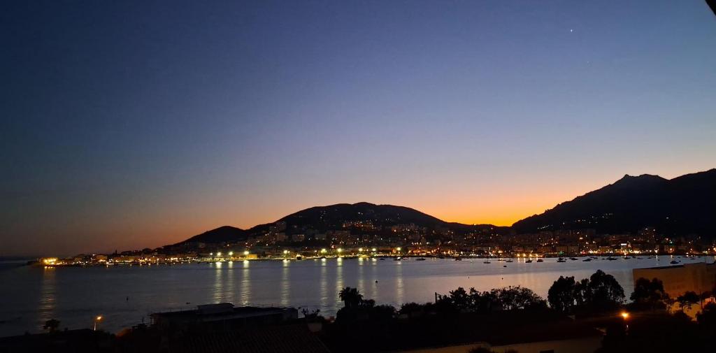a view of a city and a lake at night at Casa cesari in Ajaccio